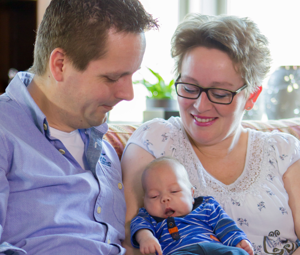 Mom and Dad holding newborn son