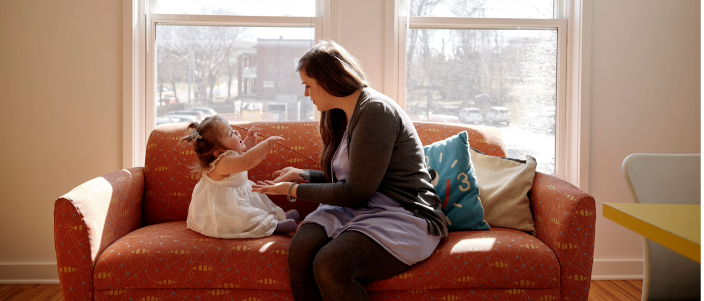 Mom and daughter sitting on sofa