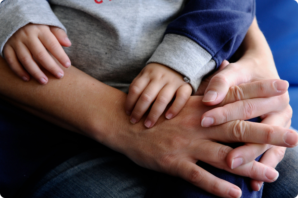 Close up of parent and child holding hands